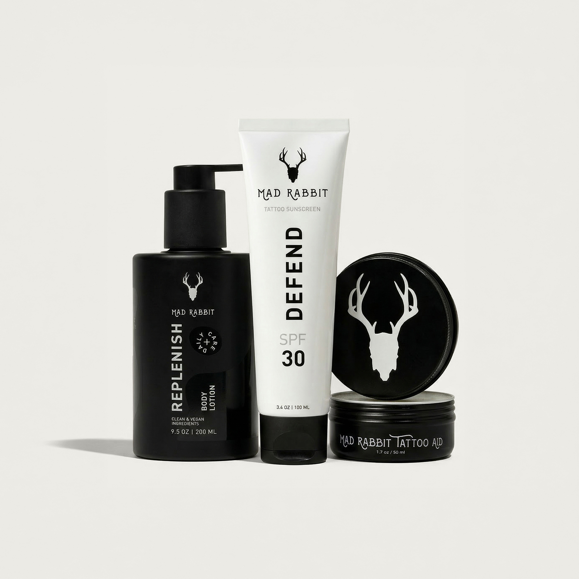 Mad Rabbit tattoo aftercare bundle — daily lotion, tattoo balm stick, and SPF sunscreen